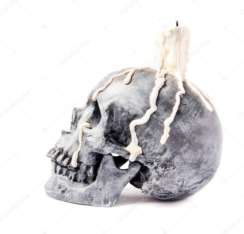 Scary halloween skull with melted candle