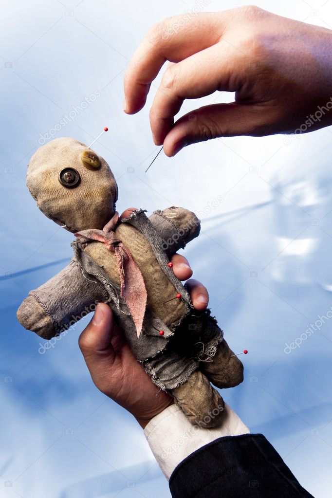 Photo of Businessman making voodoo to co-worker