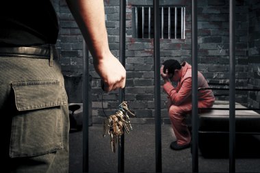 Prison guard with keys outside dark prison cell clipart