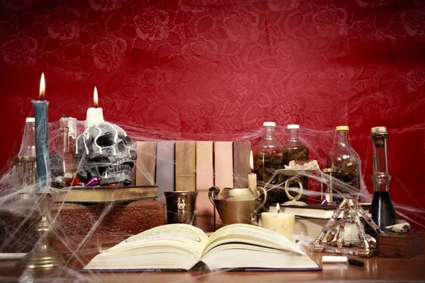 stock image Low angle view of table full of witchcraft related objects and cobwebs