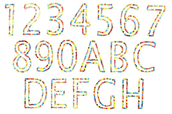 Abc and numbers in upper caps made of candy isolated on white. — Stock Photo, Image