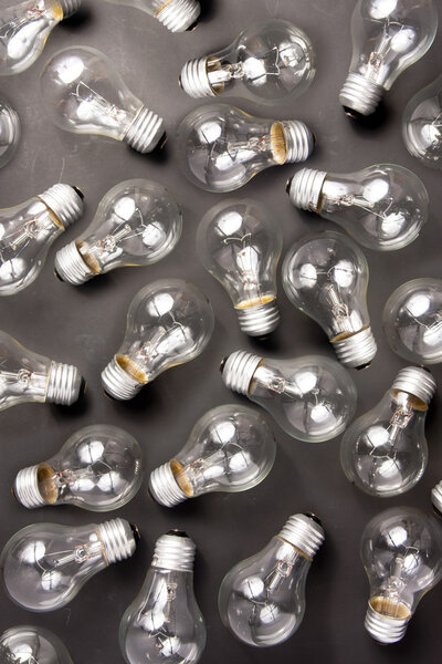 Many light bulbs lying on black backround