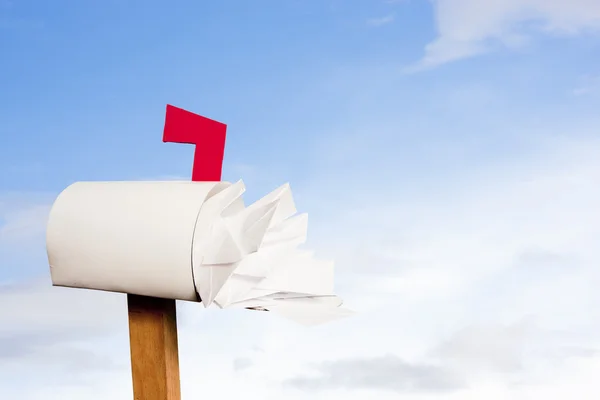 Briefkasten überquillt vor Post gegen den Himmel — Stockfoto