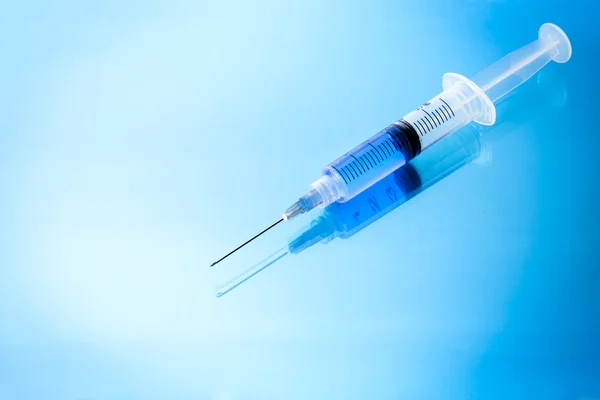 Medical Syringe on glossy background — Stock Photo, Image