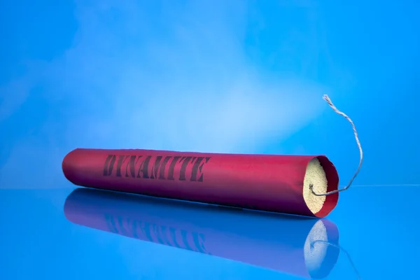Dynamite stick em um fundo azul — Fotografia de Stock