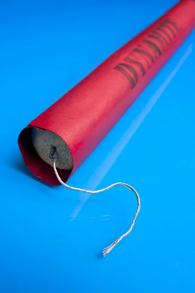 Dynamite stick on a blue background — Stock Photo, Image