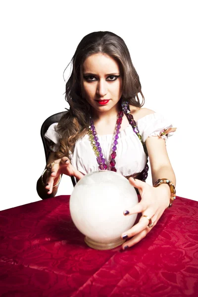 Pretty gypsy woman with her crystal ball predicting the future isolated on white — Stock Photo, Image