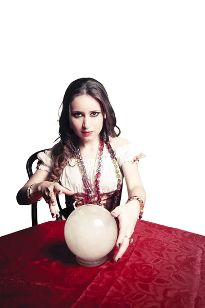 Pretty gypsy woman with her crystal ball predicting the future isolated on white — Stock Photo, Image