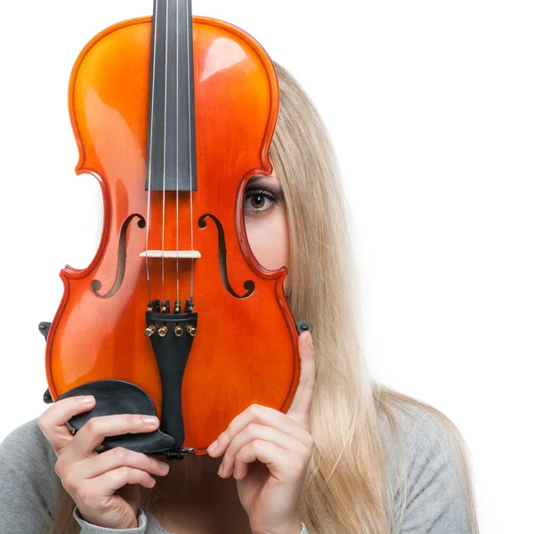 Young girl holding a violin and looking through it — Stock Photo, Image