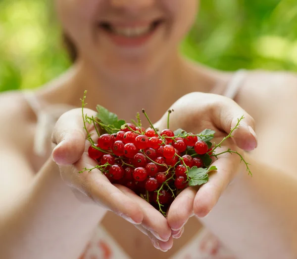 stock image Girl holding a handful of red currants