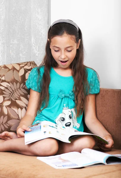 Het verrast meisje is het lezen van een krant — Stockfoto