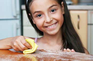 The girl is cleaing the dust clipart