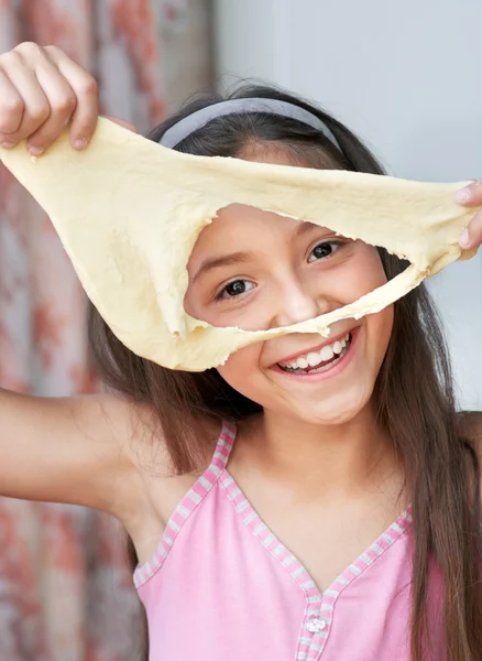The girl is shoeing the dough — Stock Photo, Image