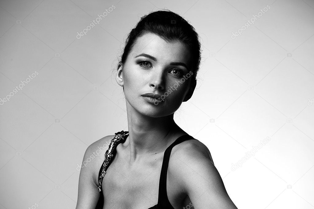 Portrait of luxury woman in exclusive jewelry on natural backgro