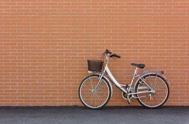 Bicycle against a Brick Wall clipart