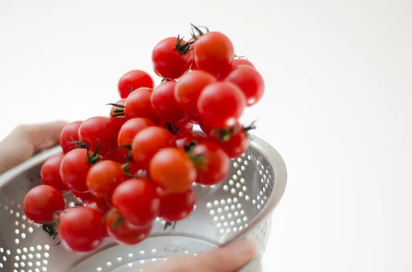 Cherry Tomatoes Tumbling Into Metal Colander — Stock Photo, Image