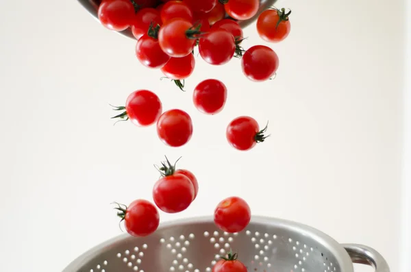 Cherry Tomatoes Tumbling Into Metal Colander — Stock Photo, Image