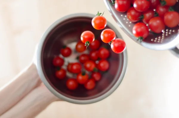 Cherry Tomatoes Tumbling From Metal Colander Into Metal Pan — Stock Photo, Image