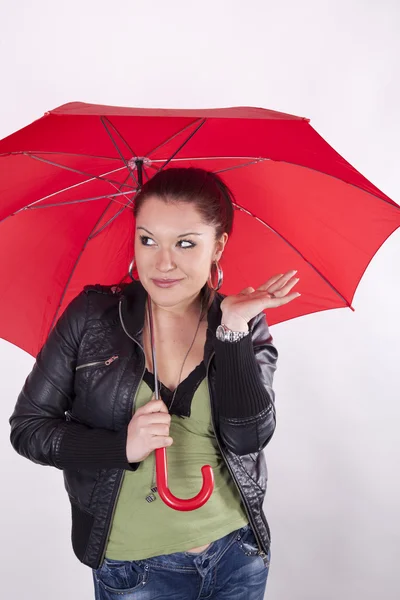 Young beautiful woman under the red umbrella — Stock Photo, Image