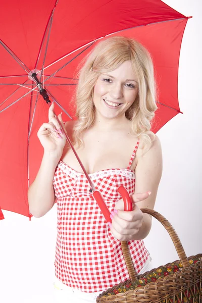 Ung attraktiv kvinna med rött paraply och korg — Stockfoto