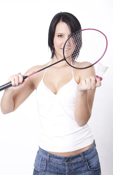 Giovane donna attraente con una racchetta badminton — Foto Stock