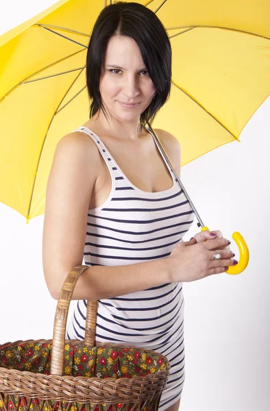 Young attractive woman with yellow umbrella — Stock Photo, Image