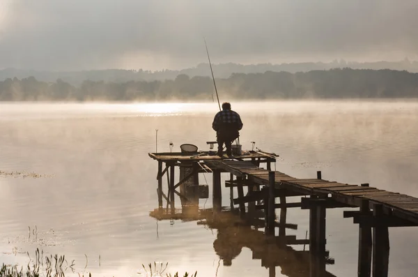stock image Fisherman to lake at first light