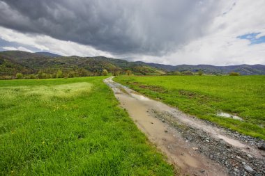 Pathway on green ridge in mountains clipart