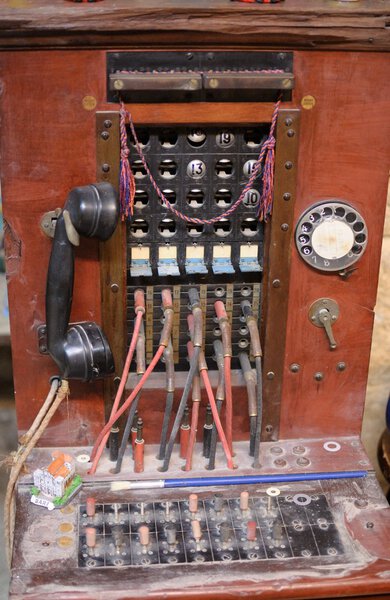 Telephone exchange old for traveling for 20 lines with wooden frame and rotary phone