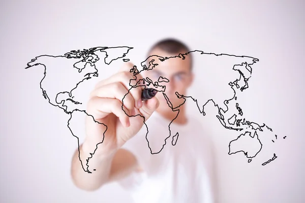Young man drawing a world map — Stock Photo, Image