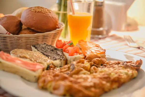 stock image Breakfast with juice, omelette, sandwich, jamon and salmon