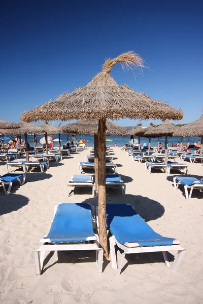 stock image Beach umbrella and deck chairs