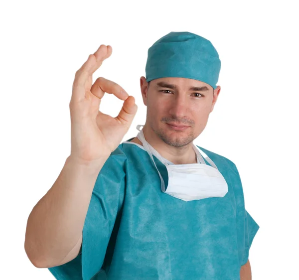 Doctor in scrubs with okay gesture — Stockfoto