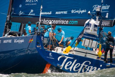 LISBON, PORTUGAL - JUNE 9: Team Telefonica in Volvo Ocean Race - Lisbon StopOver - Harbour Race June 9, 2012 in Lisbon, Portugal clipart