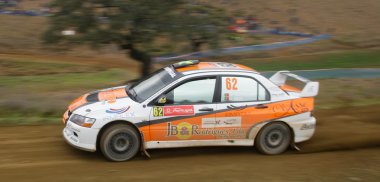 ALGARVE, PORTUGAL - MARCH 31: M. Barbosa (POR) driving is Mitsubishi LAncer EVO in Rally de Portugal 2012 on March 31, 2012 in Algarve, Portugal clipart