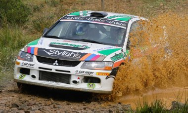 ALGARVE, PORTUGAL - MARCH 31: Fabio Frisiero (ITA) driving is Mitsubishi Lancer EVO in Rally de Portugal 2012 on March 31, 2012 in Algarve, Portugal clipart