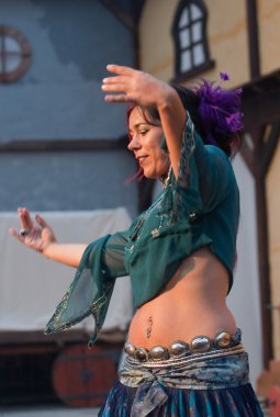 OBIDOS, PORTUGAL - JULY 26: Belly dancer performing in Medieval Market of Obidos 2012 July 26, 2012 in Obidos, Portugal clipart