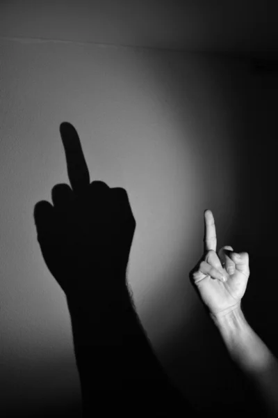 Mão sombra Foda dedo, preto e branco Imagem De Stock