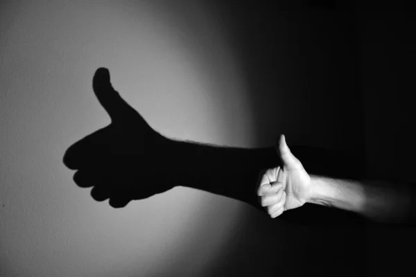 Hand shadow of good work, black and white Лицензионные Стоковые Фото