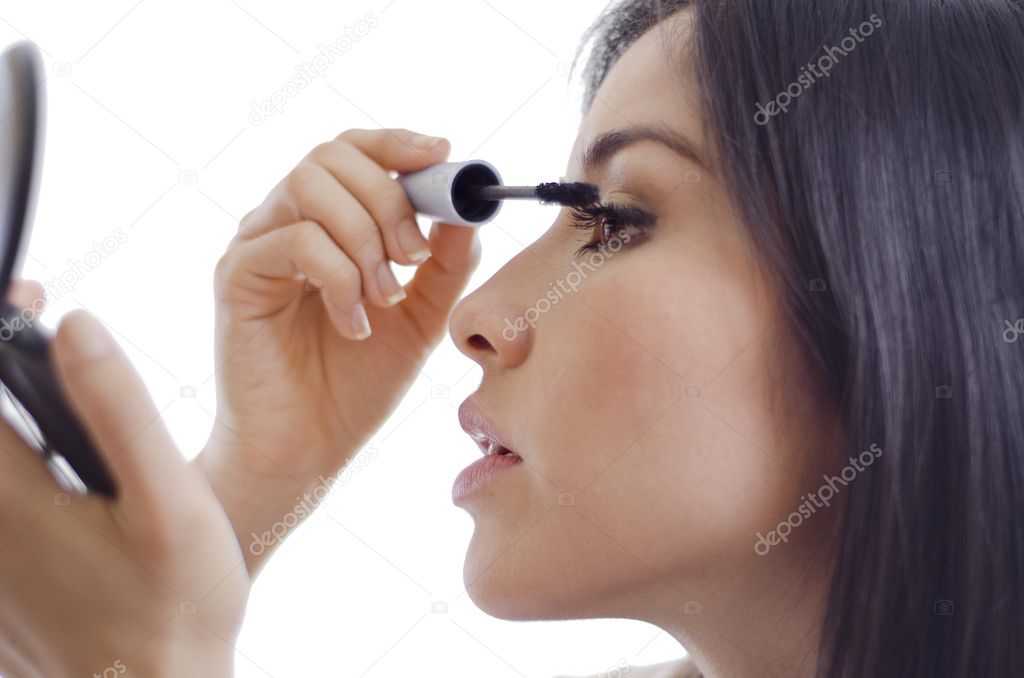 Cute girl putting some mascara