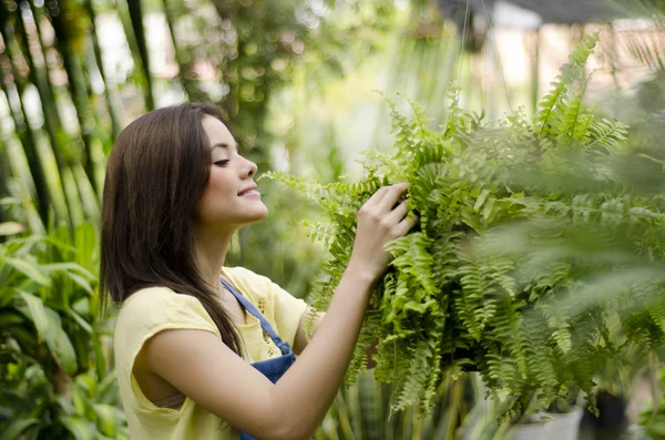 Girl plating some flowers — Stock Photo, Image