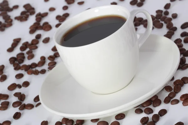 Kopje koffie en bonen in de hoek — Stockfoto