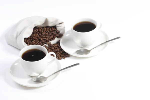 Two coffee cups with coffee beans from bag — Stock Photo, Image
