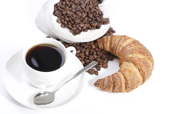 Cup of hot coffee with croissants and beans — Stock Photo, Image