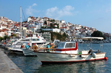 Boats in the port of Skopelos a Greek island clipart