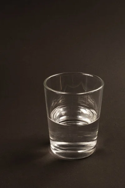 stock image Half full or half empty glass of water
