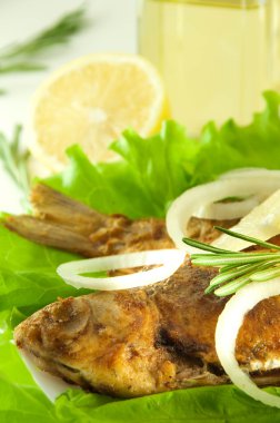 Fish fried, a crucian with a lemon, rosemary and olive oil