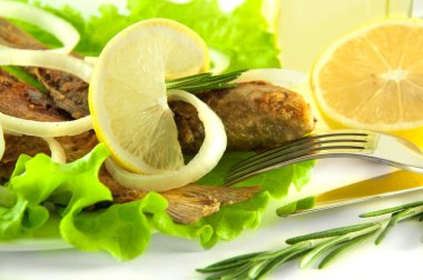 Fish fried, a crucian with a lemon, rosemary and olive oil