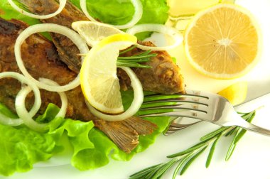 Fish fried, a crucian with a lemon, rosemary and olive oil