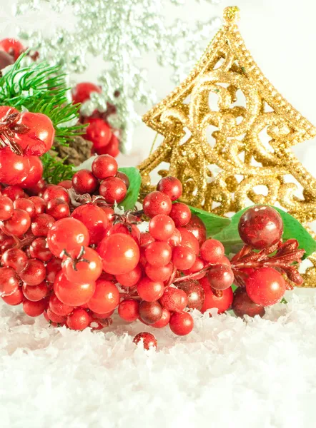 Christmas branch of berries with a gold fur-tree against snow — Stock Photo, Image